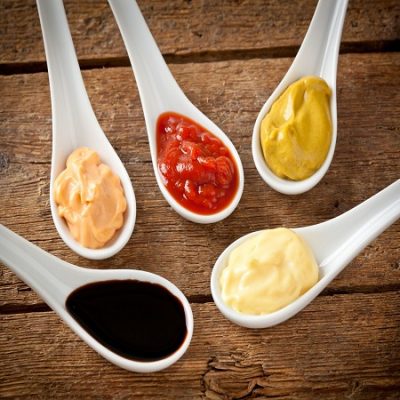 18654409 - sauces mixed in the ceramic spoons